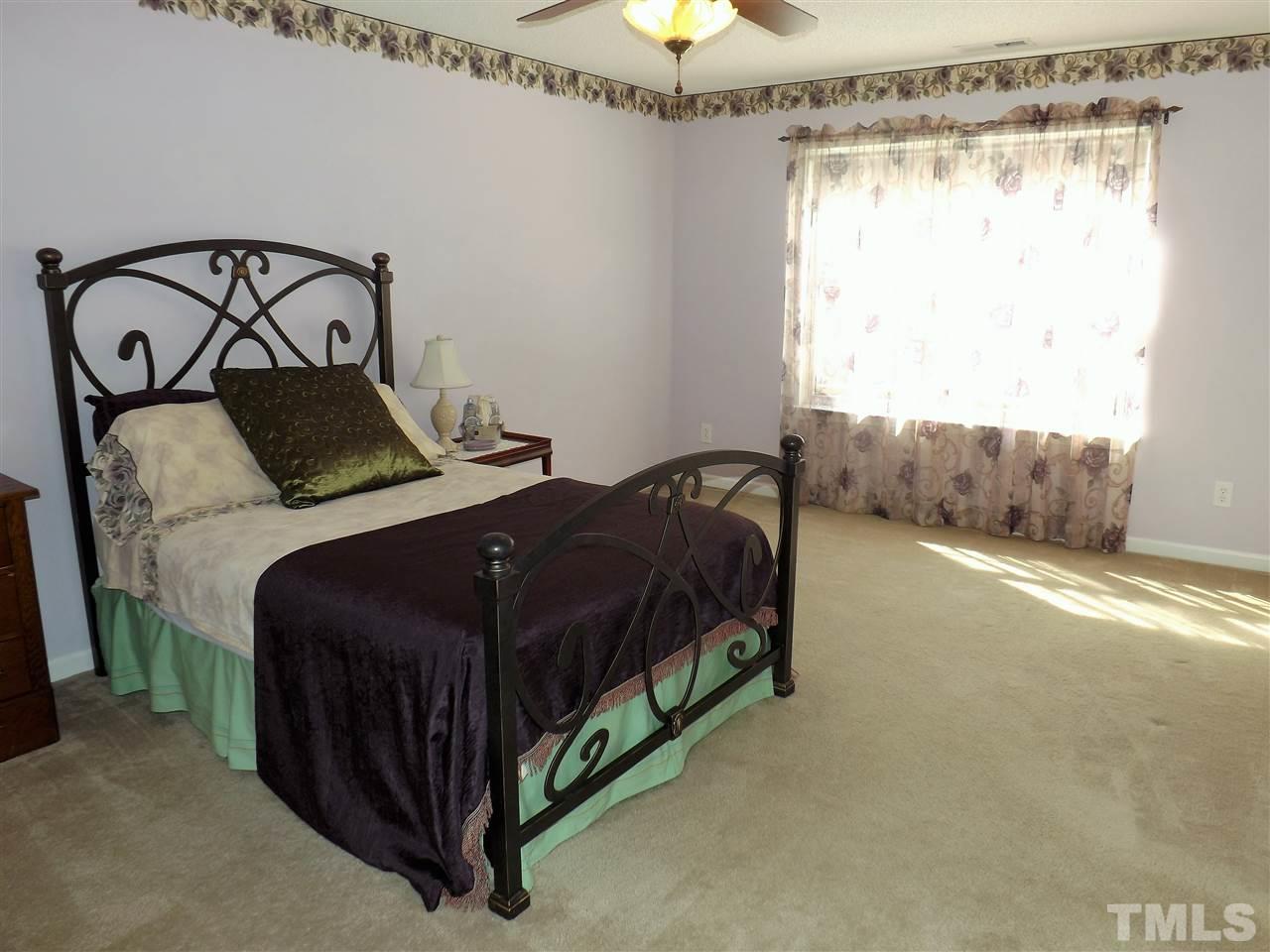 4904 Marathon Lane Raleigh, NC 27616 - Photo 17 of 25 a bedroom with a bed mirror and window