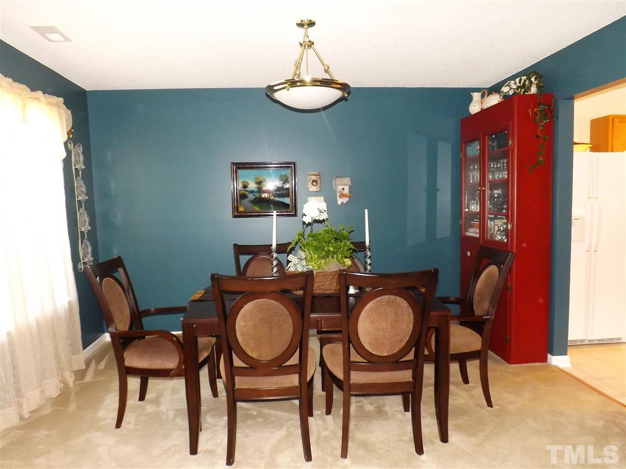 4904 Marathon Lane Raleigh, NC 27616 - Photo 4 of 25 a dining room with furniture a chandelier and window