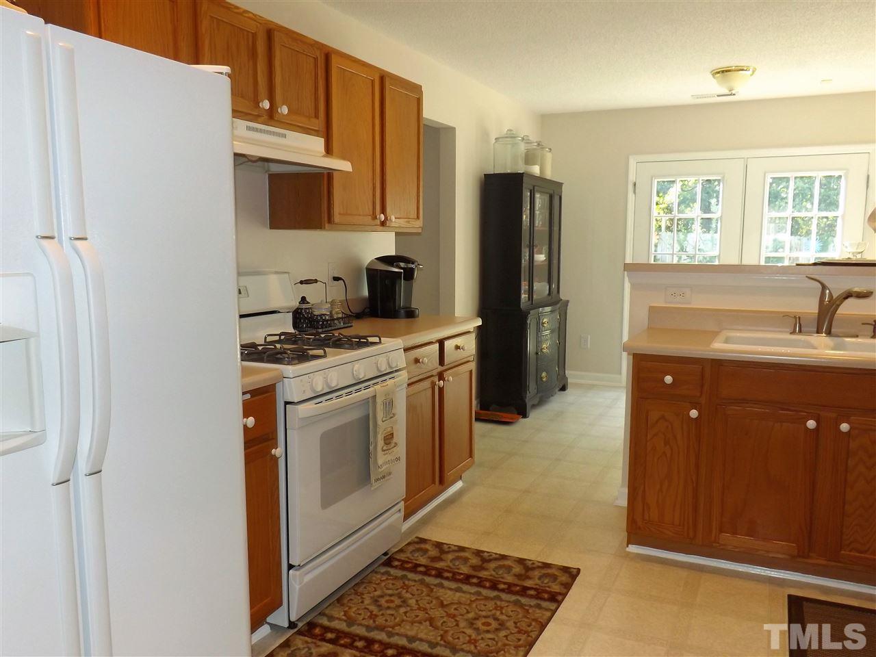 4904 Marathon Lane Raleigh, NC 27616 - Photo 6 of 25 a kitchen with stainless steel appliances granite countertop a refrigerator a stove and a sink