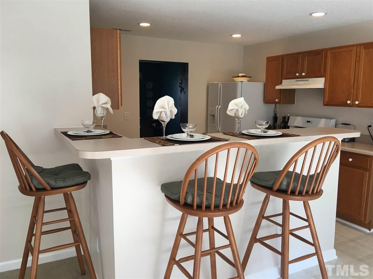 4904 Marathon Lane Raleigh, NC 27616 - Photo 8 of 25 a kitchen with a table chairs and a stove