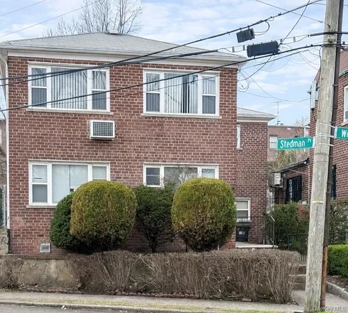 a view of a brick house with a large windows