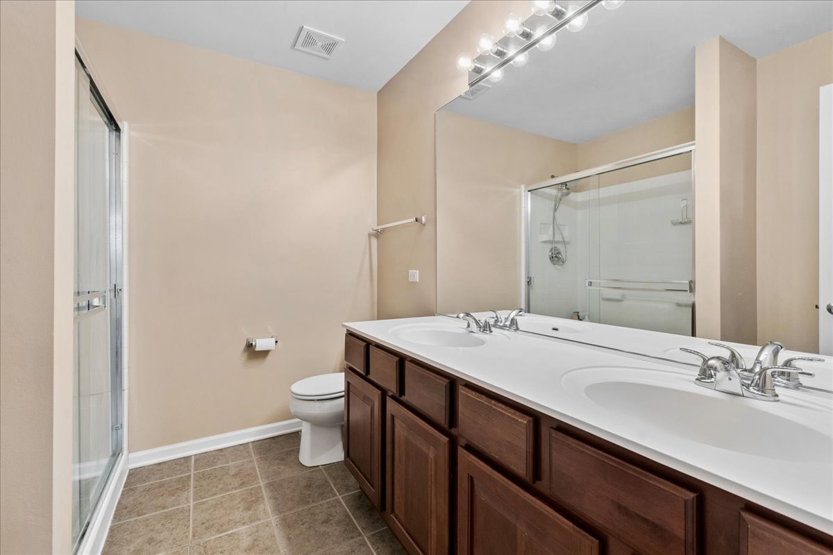 2459 Anna Way Elgin, IL 60124 - Photo 12 of 20 a bathroom with a double vanity sink toilet and a mirror