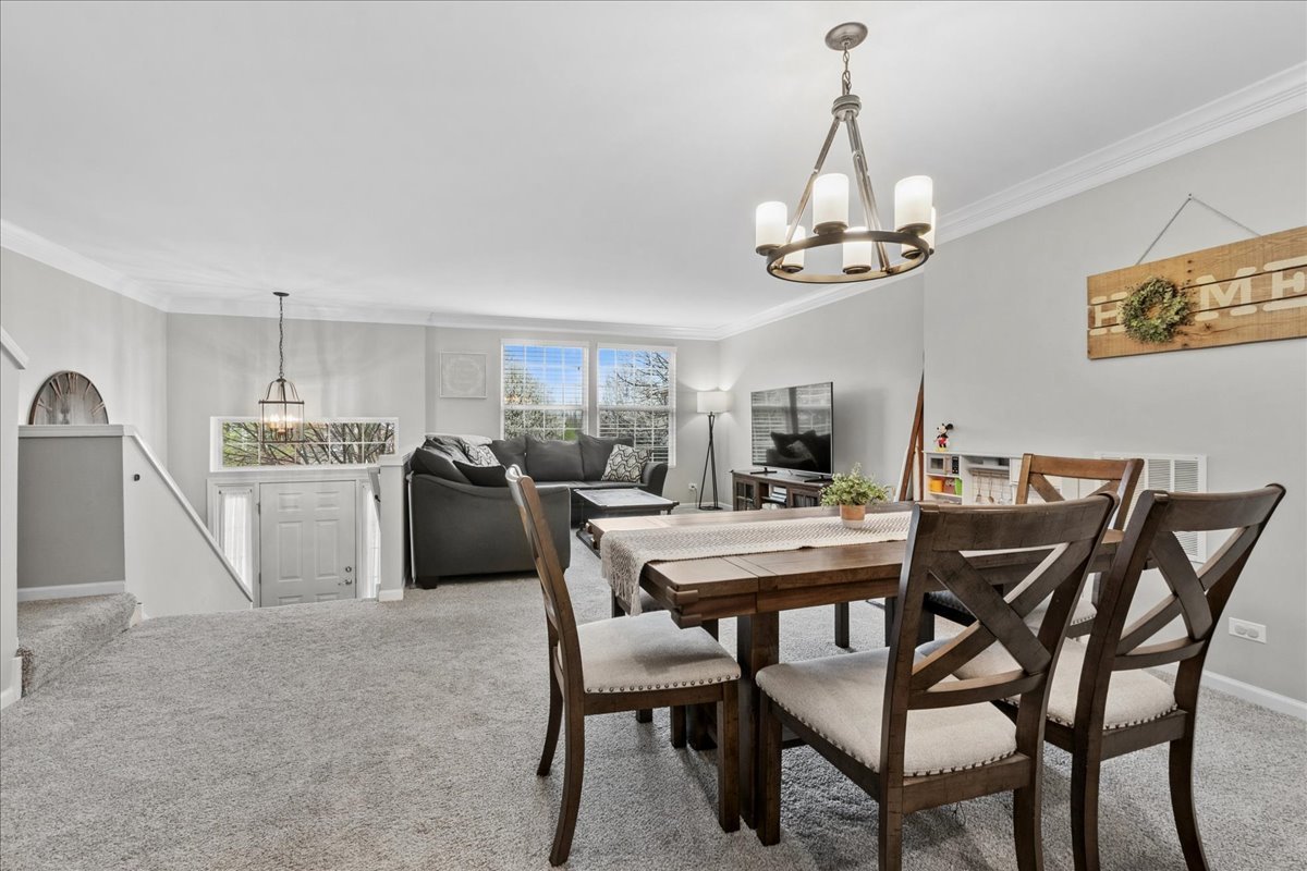 2459 Anna Way Elgin, IL 60124 - Photo 4 of 20 a view of a dining room with furniture window and wooden floor