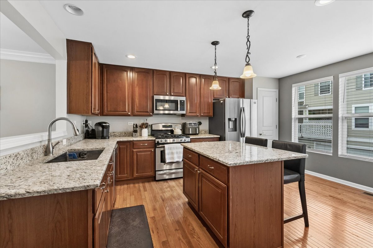2459 Anna Way Elgin, IL 60124 - Photo 7 of 20 a kitchen with granite countertop a sink counter top space appliances and cabinets