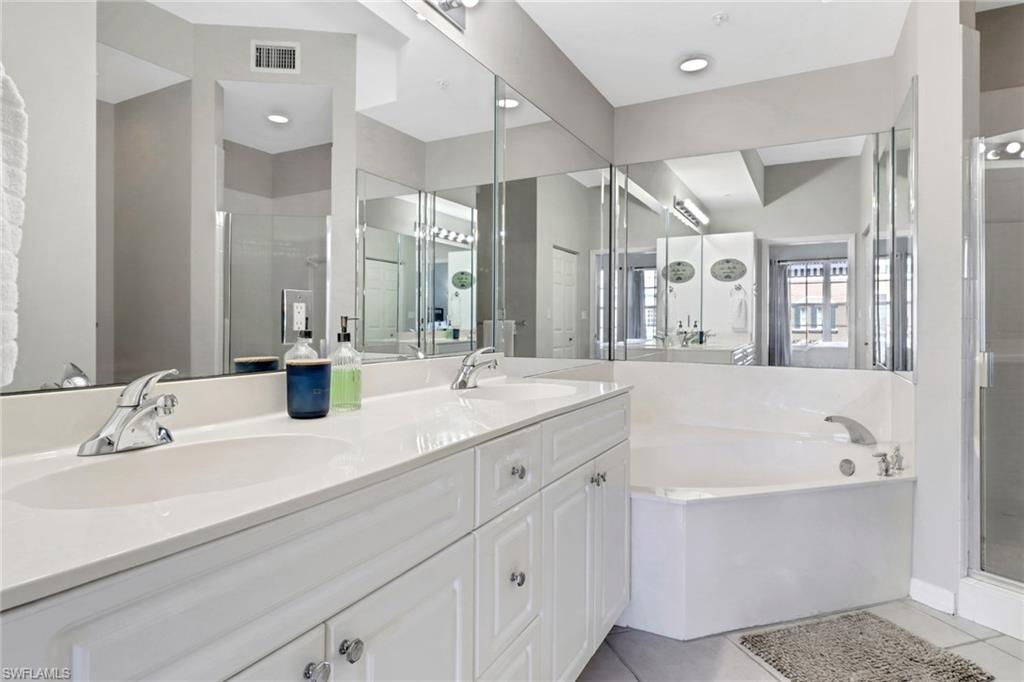 401 Bayfront Place, Unit 3502 Naples, FL 34102 - Photo 8 of 22 Full bath featuring a bath, double vanity, a shower stall, and tile patterned flooring