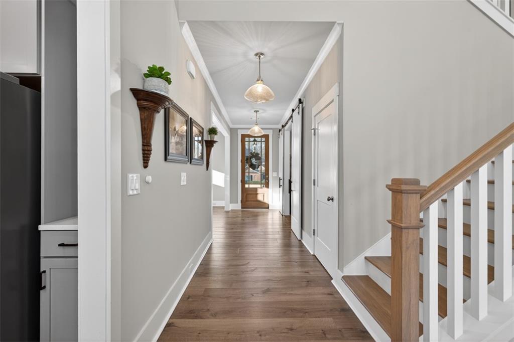 2588 Traditions Way Jefferson, GA 30549 - Photo 14 of 84 a view of a hallway with wooden floor and staircase