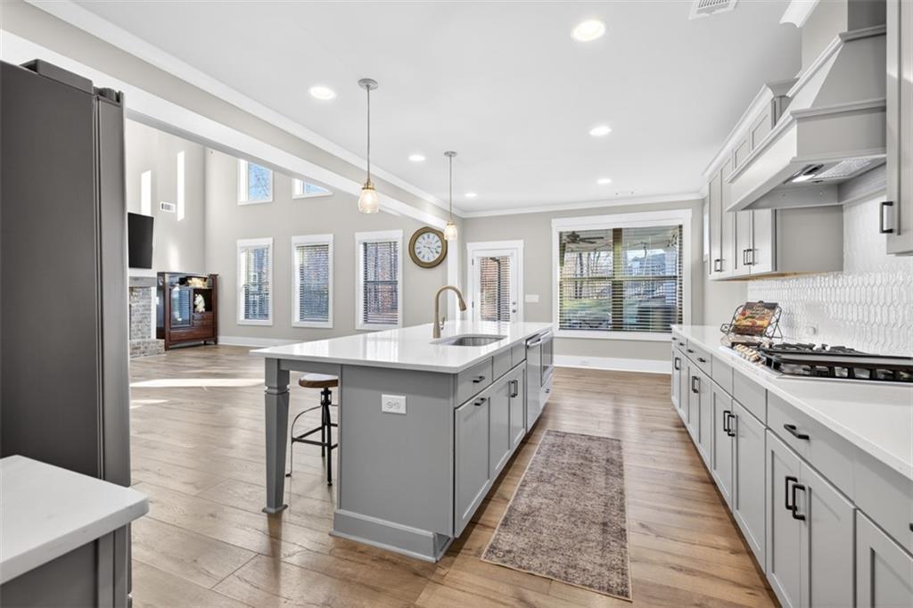 2588 Traditions Way Jefferson, GA 30549 - Photo 26 of 84 a large kitchen with stainless steel appliances kitchen island granite countertop a large stove a sink and a refrigerator