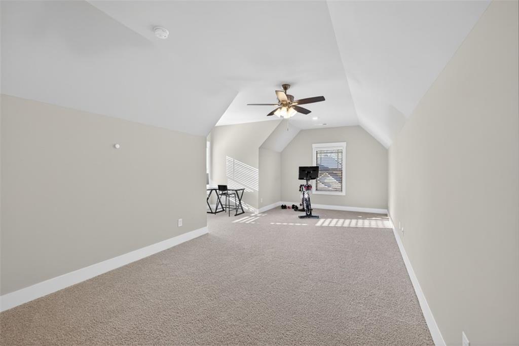 2588 Traditions Way Jefferson, GA 30549 - Photo 52 of 84 an empty room with a chandelier fan and windows