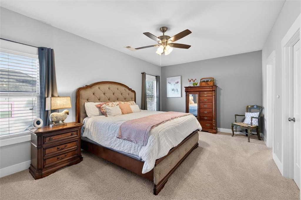 2588 Traditions Way Jefferson, GA 30549 - Photo 53 of 84 a bedroom with a bed and a chandelier