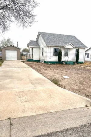 a front view of a house with a road