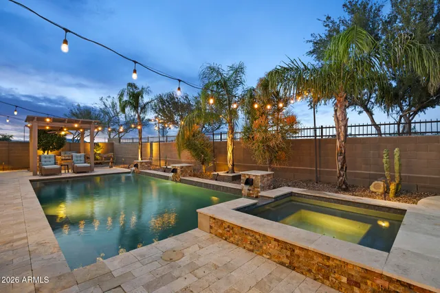 a view of a swimming pool with a patio and a yard