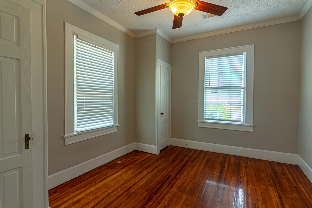 1519 16th Avenue Columbus, GA 31901 - Photo 14 of 16 a view of an empty room with wooden floor and a window