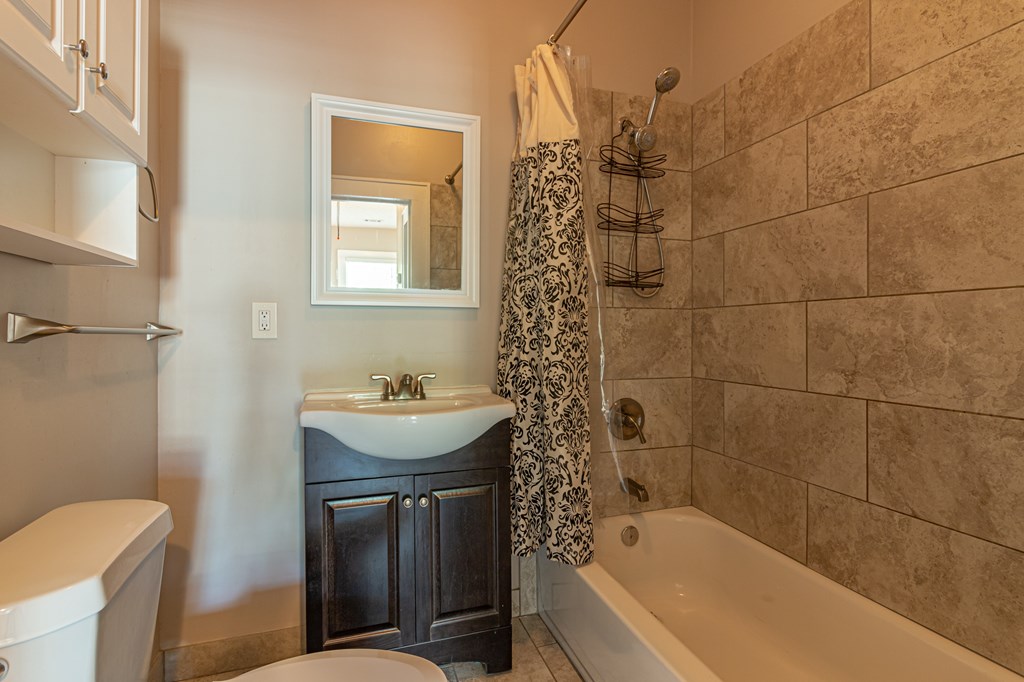 1519 16th Avenue Columbus, GA 31901 - Photo 16 of 16 a bathroom with a sink a toilet and shower
