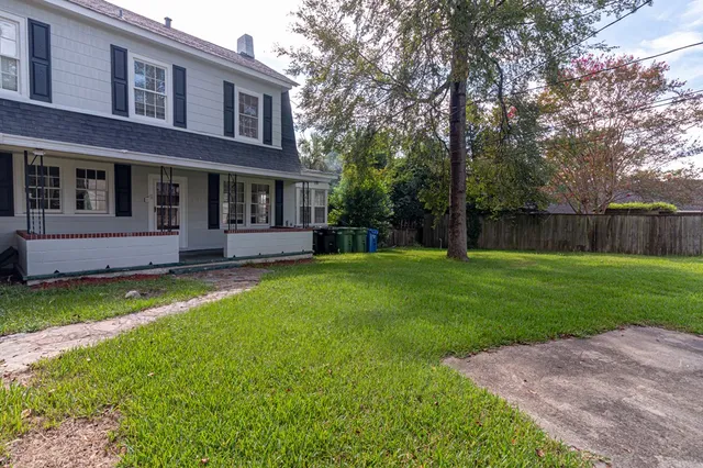 a front view of house with yard and green space