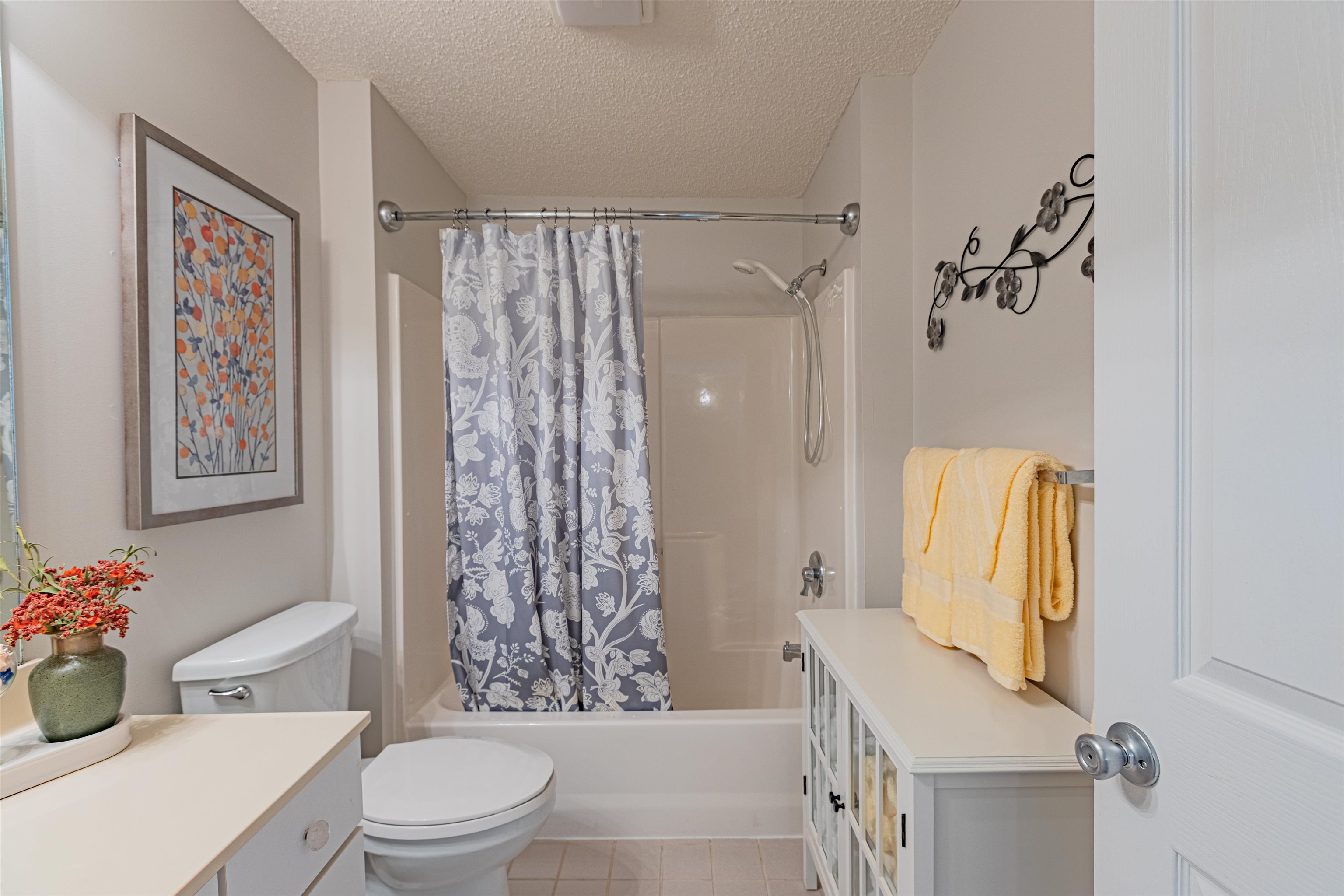4603 Arran Court, Unit A Myrtle Beach, SC 29579 - Photo 11 of 32 Bathroom featuring vanity, shower / bath combination with curtain, a textured ceiling, and light tile patterned floors