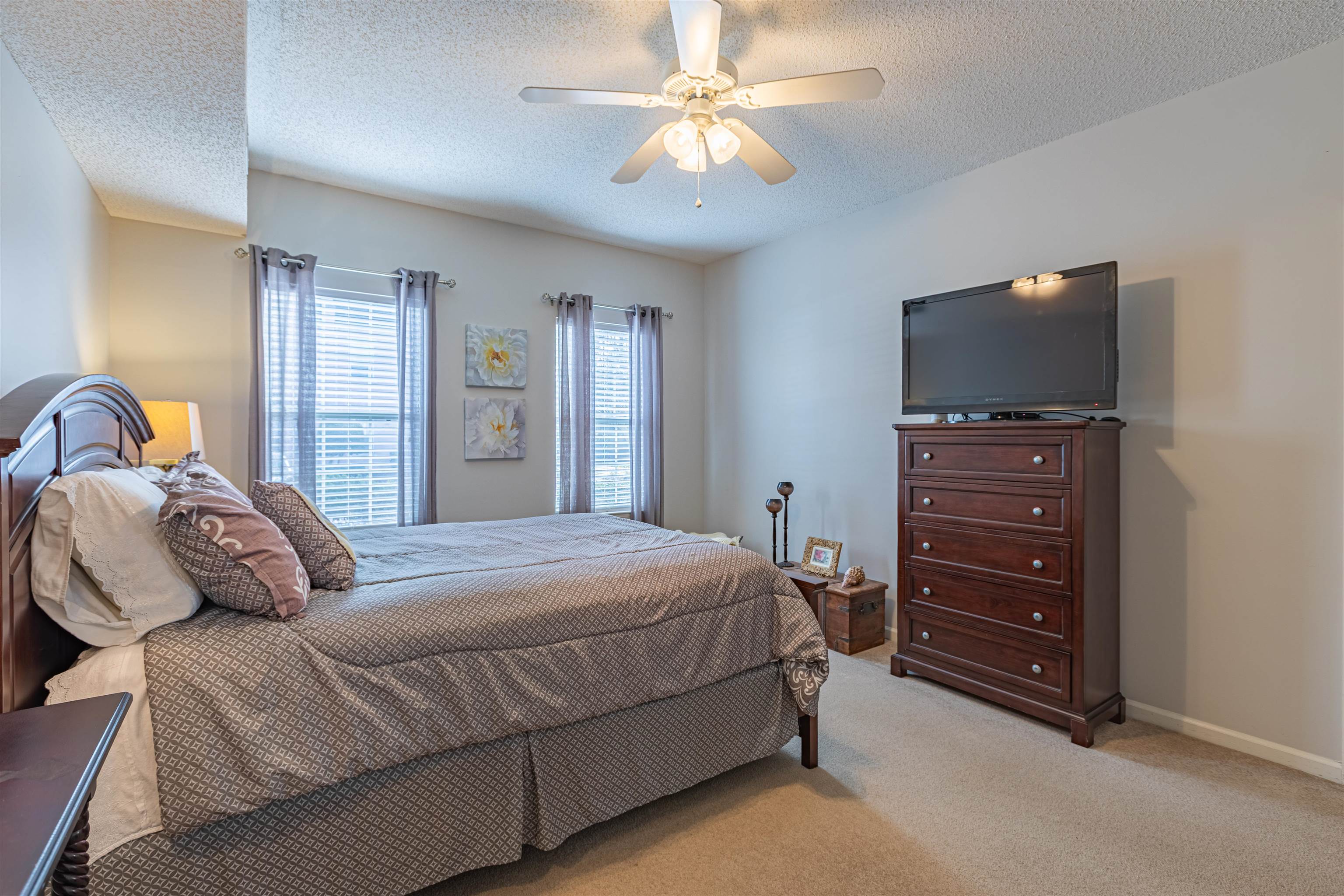 4603 Arran Court, Unit A Myrtle Beach, SC 29579 - Photo 13 of 32 Bedroom with light colored carpet, a ceiling fan, and a textured ceiling
