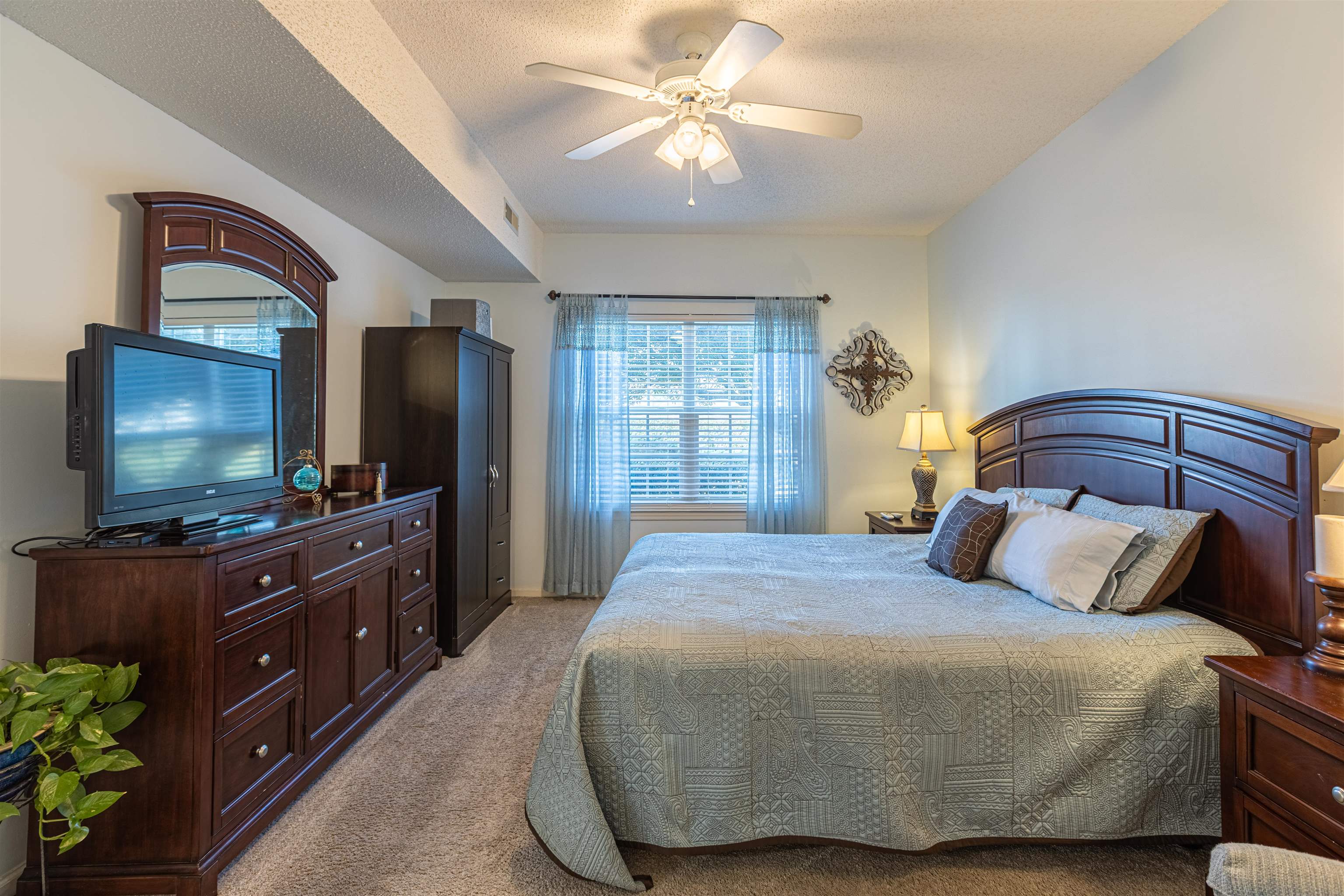 4603 Arran Court, Unit A Myrtle Beach, SC 29579 - Photo 16 of 32 Bedroom with a textured ceiling, light carpet, and a ceiling fan