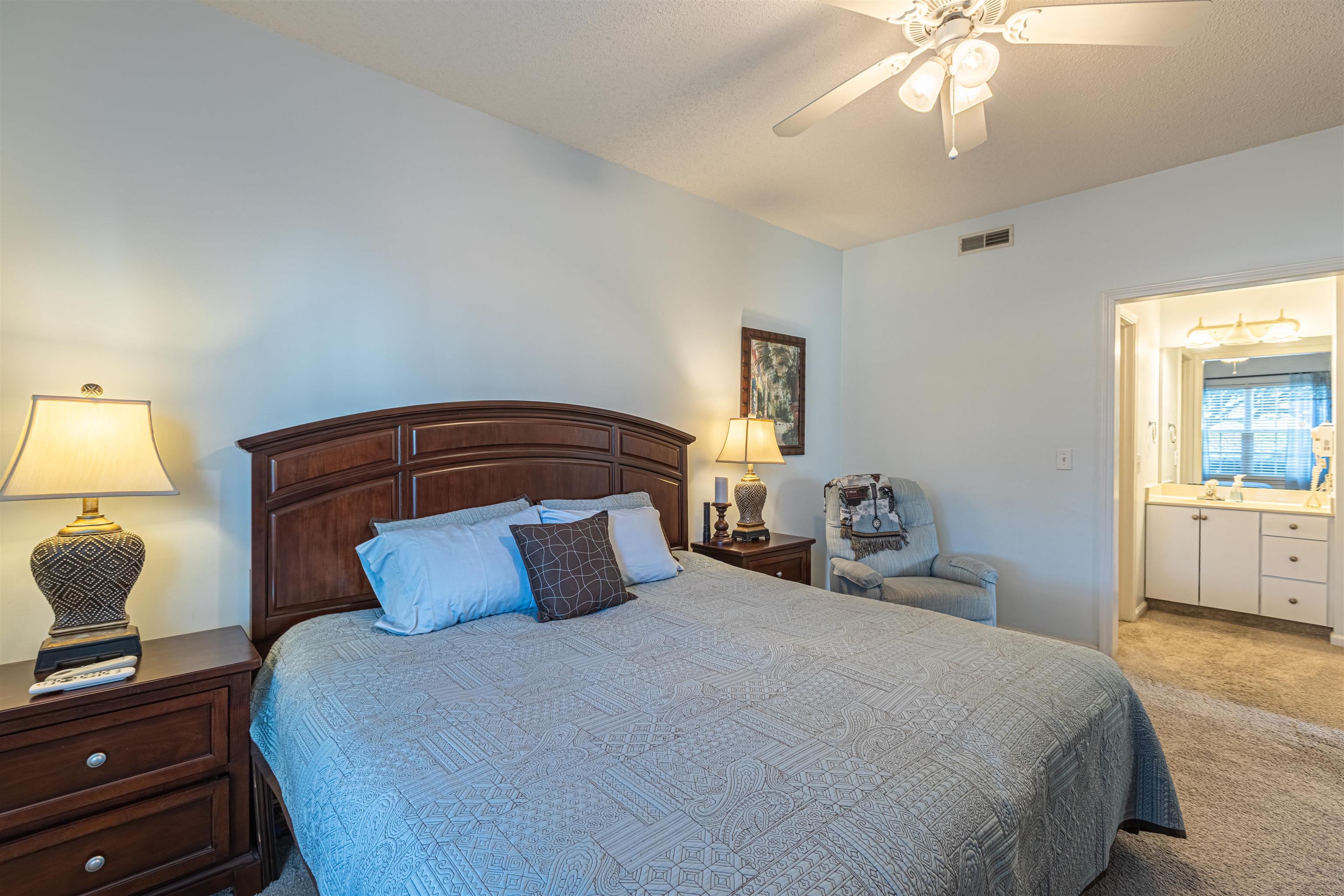 4603 Arran Court, Unit A Myrtle Beach, SC 29579 - Photo 17 of 32 Bedroom featuring light carpet, ceiling fan, and a textured ceiling