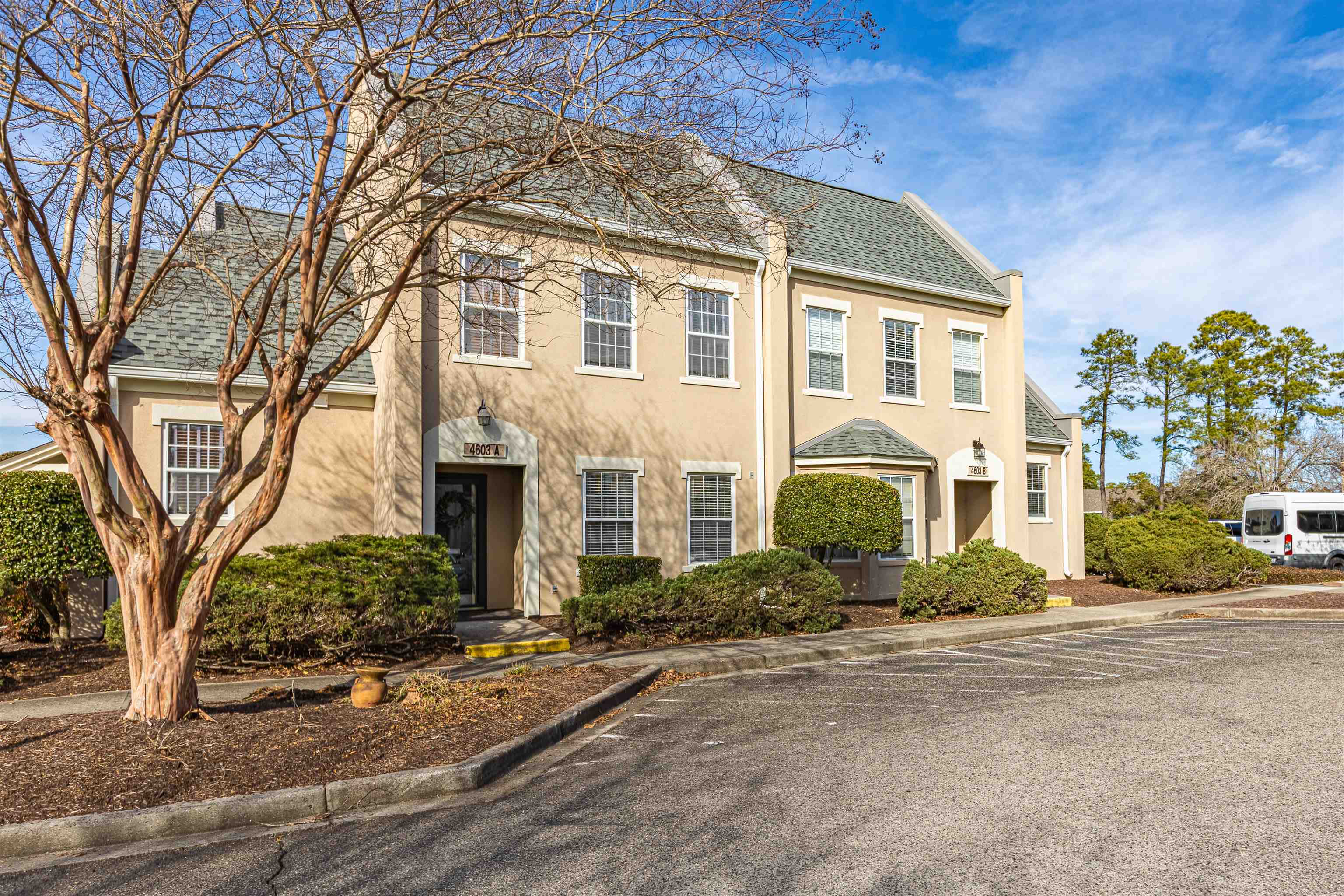 4603 Arran Court, Unit A Myrtle Beach, SC 29579 - Photo 2 of 32 Colonial-style house featuring stucco siding, uncovered parking, and roof with shingles