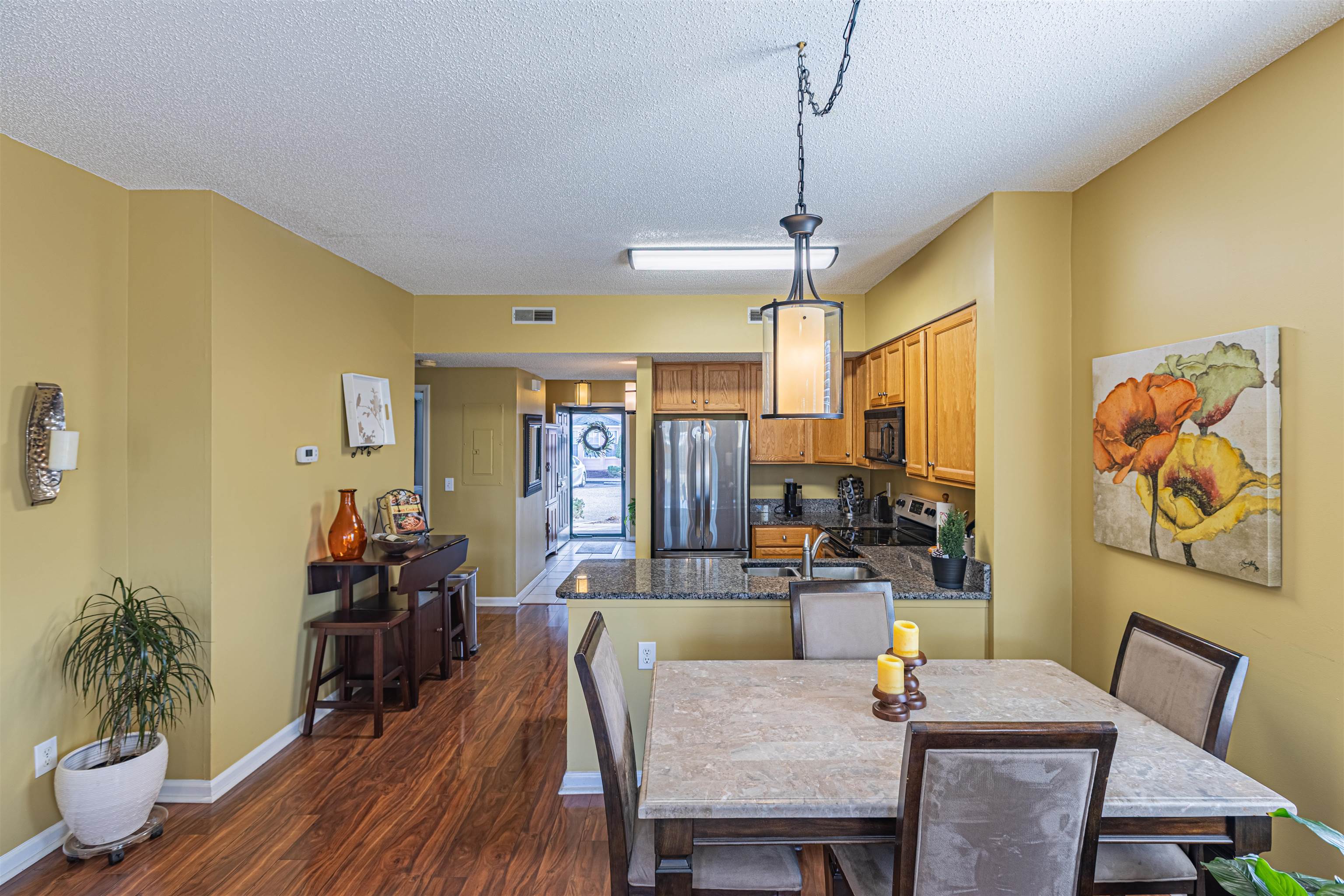 4603 Arran Court, Unit A Myrtle Beach, SC 29579 - Photo 5 of 32 Dining area featuring dark wood-style flooring and a textured ceiling