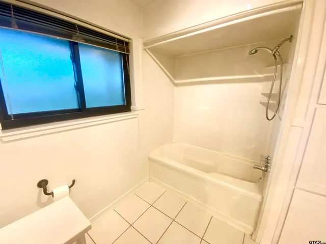 a bathroom with a bathtub and shower