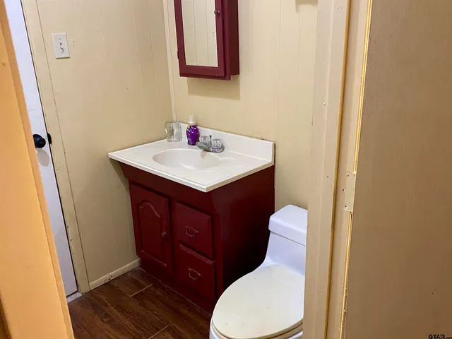 a bathroom with a toilet sink and mirror