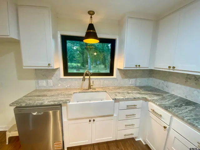 a kitchen with a sink stove and cabinets
