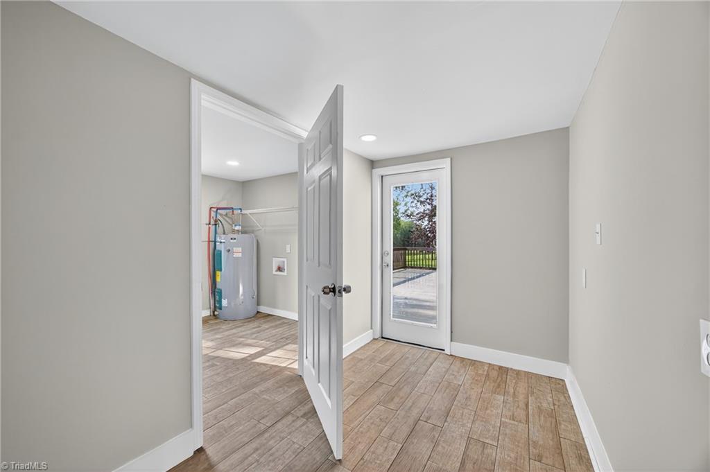 937 Haynes Road Summerfield, NC 27358 - Photo 17 of 50 Half bath and utility off the mudroom entrance in rear/side.