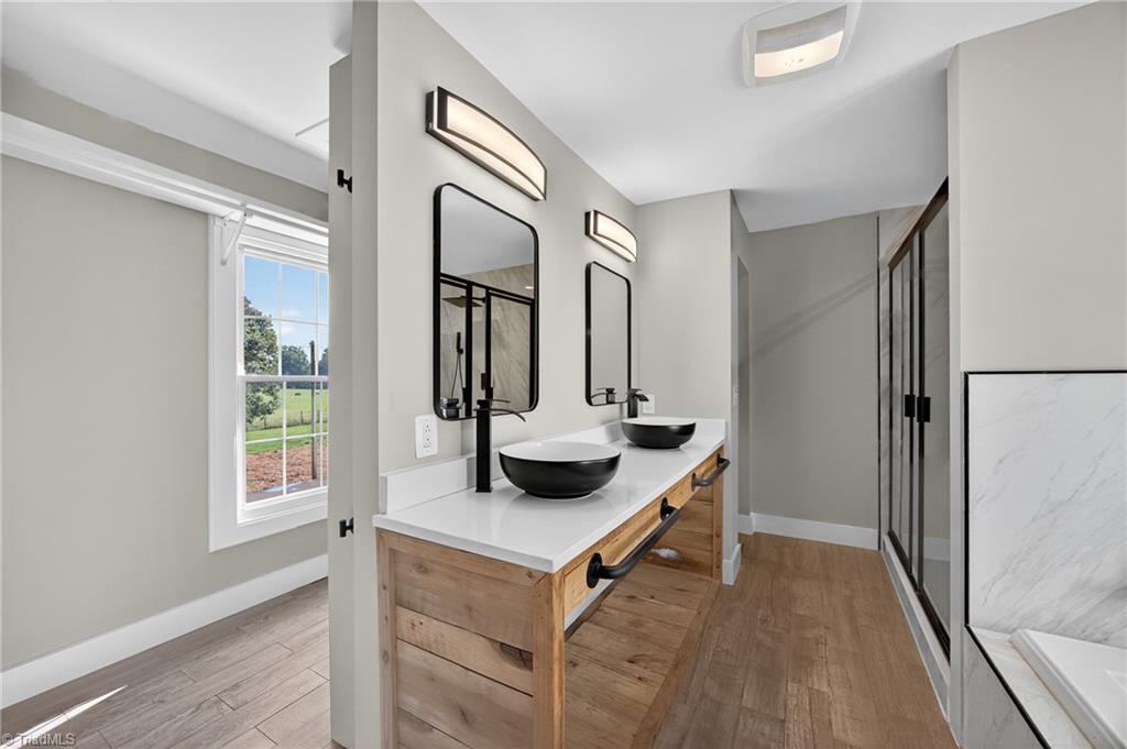 937 Haynes Road Summerfield, NC 27358 - Photo 37 of 50 Custom double vanity in primary ensuite bathroom (Upstairs).