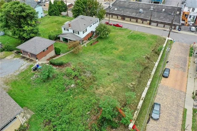 an aerial view of a house with swimming pool garden and patio