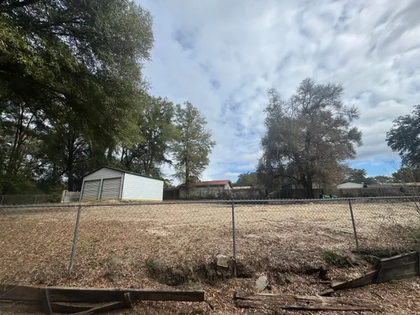a front view of a house with trees