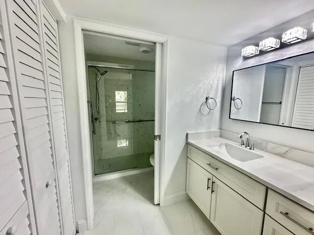 a spacious bathroom with a shower sink and mirror