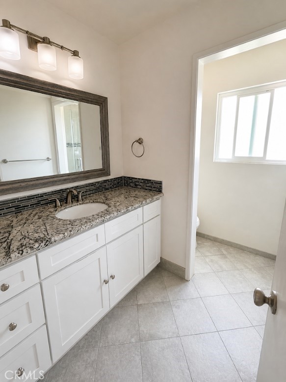 20631 East Vejar Road Walnut, CA 91789 - Photo 14 of 19 a bathroom with a granite countertop sink and a mirror
