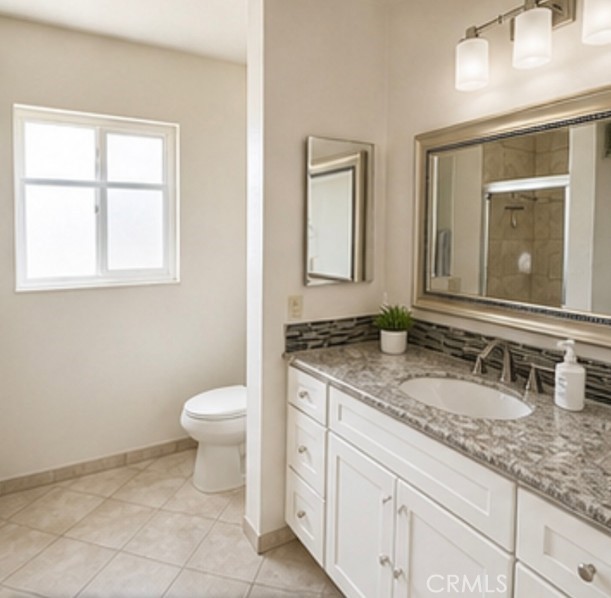 20631 East Vejar Road Walnut, CA 91789 - Photo 6 of 19 a bathroom with a granite countertop toilet sink and mirror