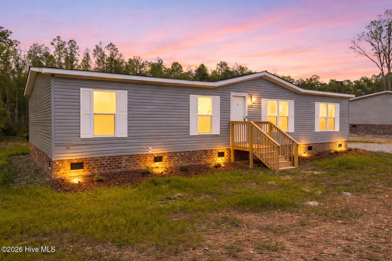 1735 Lynch Road Hollister, NC 27844 - Photo 1 of 39 Twilight glow on a rural home