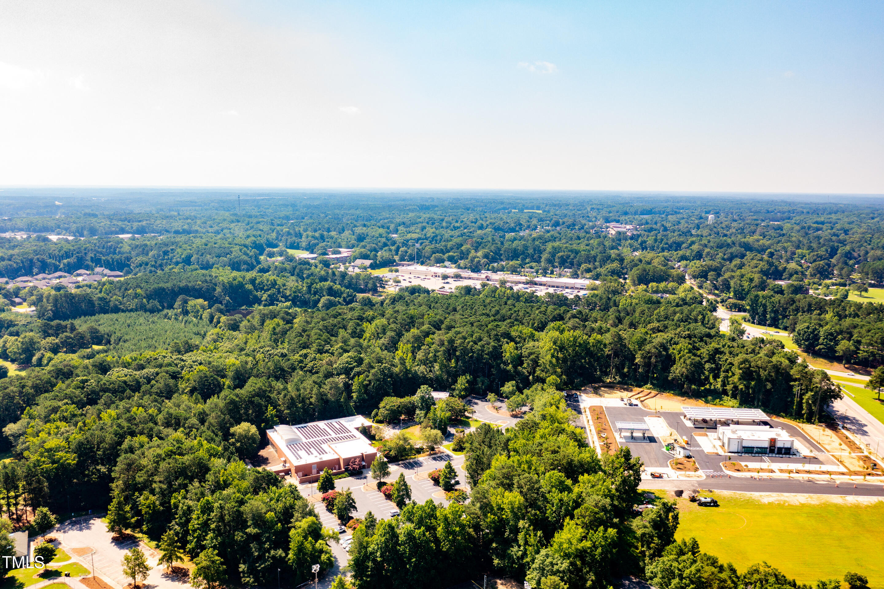 1213 Shepard School Road Zebulon, NC 27597 - Photo 8 of 8 an aerial view of residential houses with outdoor space and trees