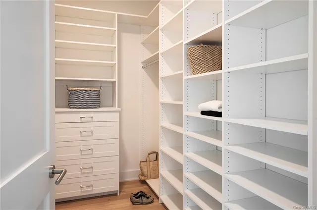 a view of walk in closet with empty racks