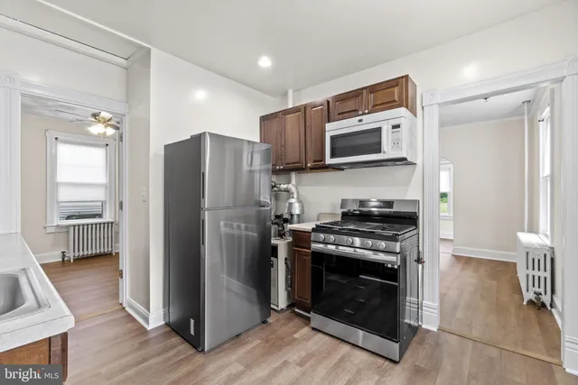 a kitchen with a stove top oven and refrigerator