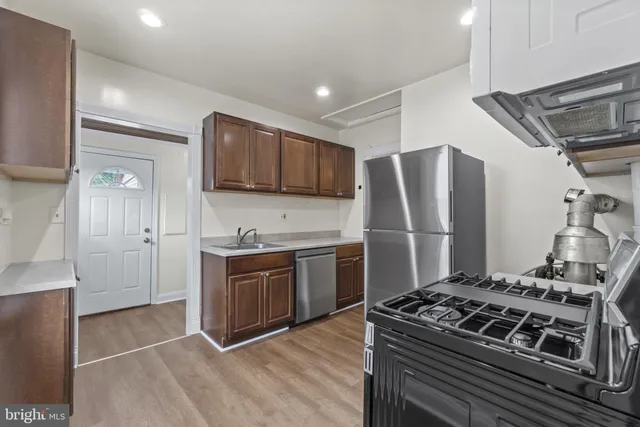 a kitchen with stainless steel appliances granite countertop a stove and a refrigerator