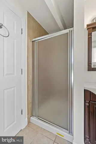a bathroom with a glass shower door