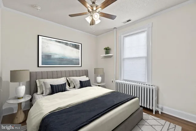 a bedroom with a bed and a painting on the wall