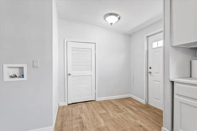 a view of empty room with wooden floor