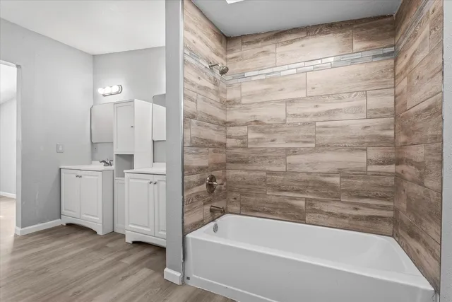 a bathroom with a bathtub and a sink