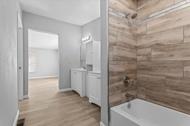 a bathroom with a bathtub and shower