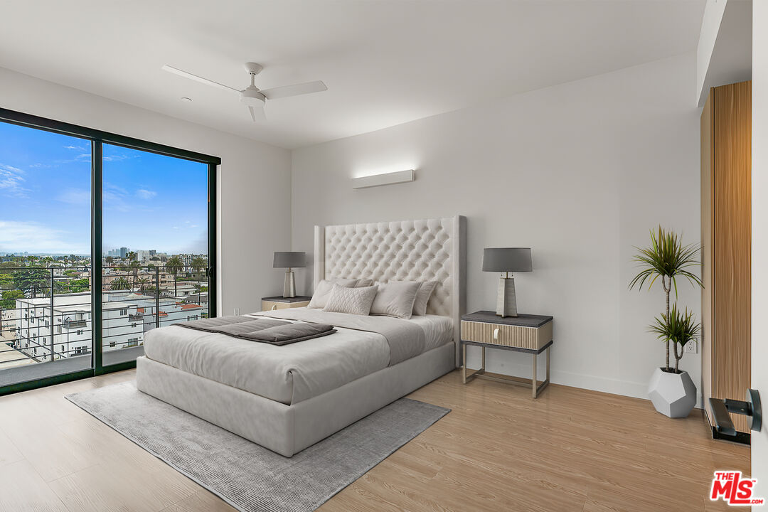 3688 Overland Avenue, Unit PH14 Los Angeles, CA 90034 - Photo 12 of 37 a living room with furniture and a large window