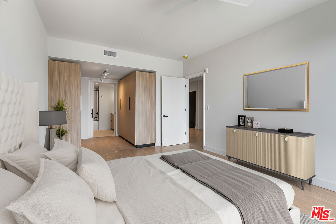 3688 Overland Avenue, Unit PH14 Los Angeles, CA 90034 - Photo 13 of 37 a bedroom with a bed and a flat screen tv
