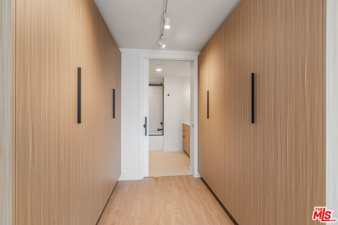 3688 Overland Avenue, Unit PH14 Los Angeles, CA 90034 - Photo 15 of 37 a view of a hallway with wooden floor