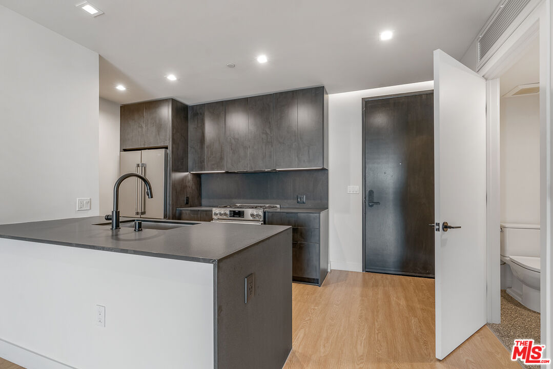 3688 Overland Avenue, Unit PH14 Los Angeles, CA 90034 - Photo 2 of 37 a kitchen with stainless steel appliances granite countertop a sink and a refrigerator
