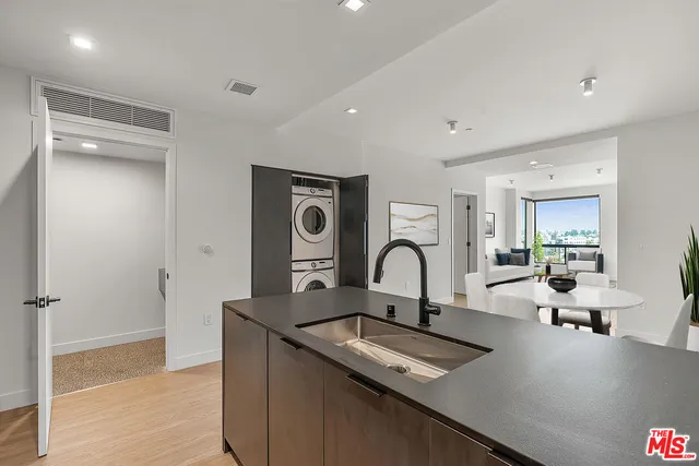 a view of a kitchen counter space a sink and wooden floor