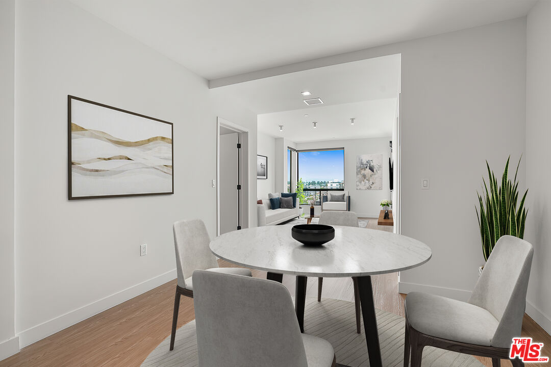 3688 Overland Avenue, Unit PH14 Los Angeles, CA 90034 - Photo 6 of 37 a view of a dining room with furniture and wooden floor